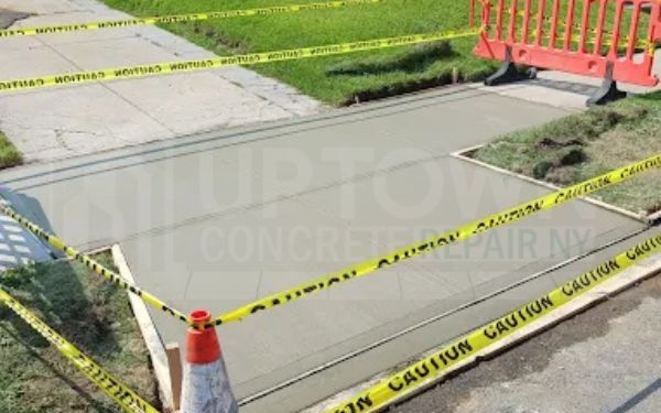 NYC DOT sidewalk violation being corrected by a concrete crew