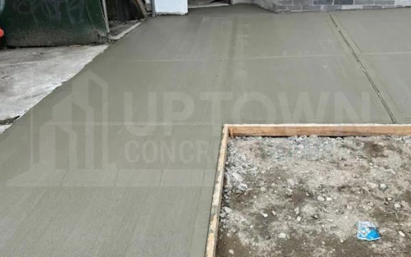 New concrete sidewalk section being poured and finished