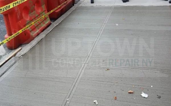 Uneven concrete slab being levelled back to grade