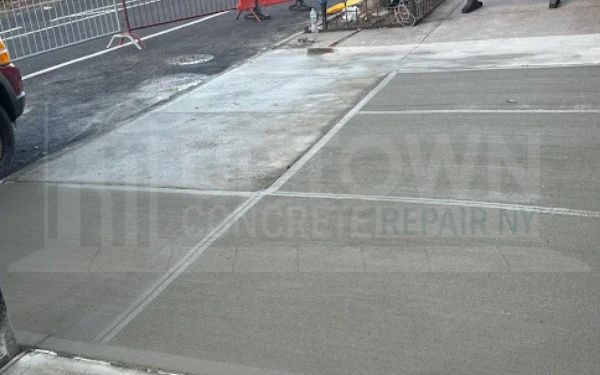 Repaired concrete sidewalk flag outside a New York City building
